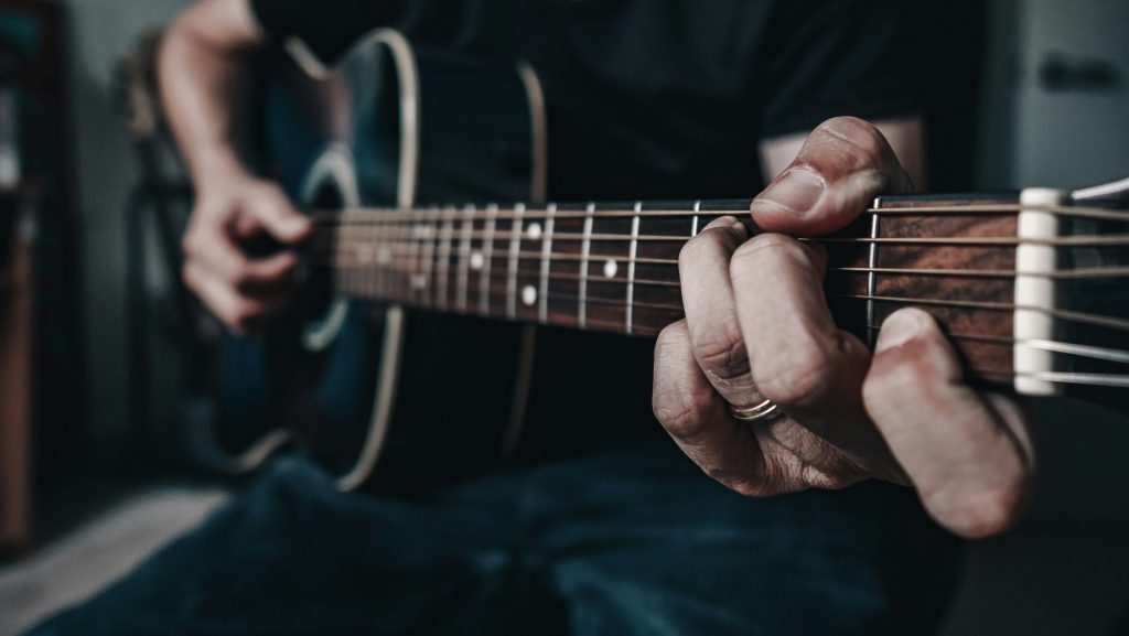 Close up of a person playing the guitar